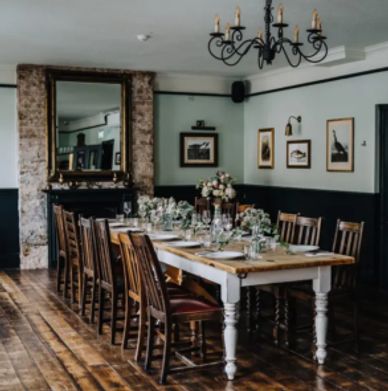 Elegant dining room with a long wooden table and classic decor.