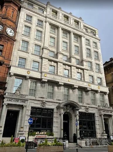 Historic multi-story building with classical architecture and arched entrance.
