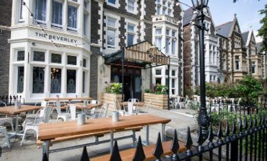 Outdoor seating at The Beverley restaurant on a sunny day.