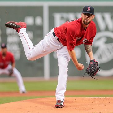 Boston Red Sox pitcher delivering a pitch on the mound.