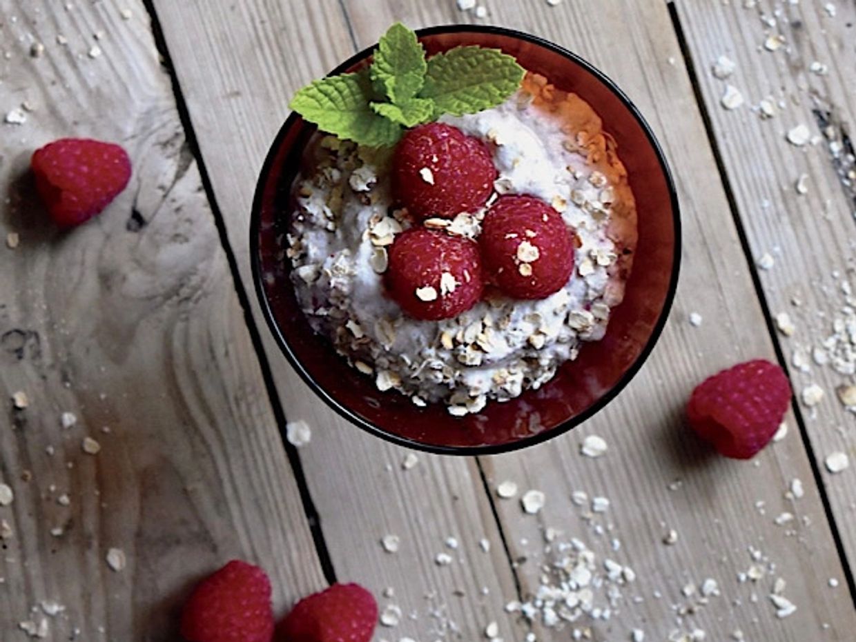 Cranachan, a modern Scottish dessert with raspberries, oats, and whipped cream. 