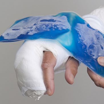 Bandaged hand with ice pack applied