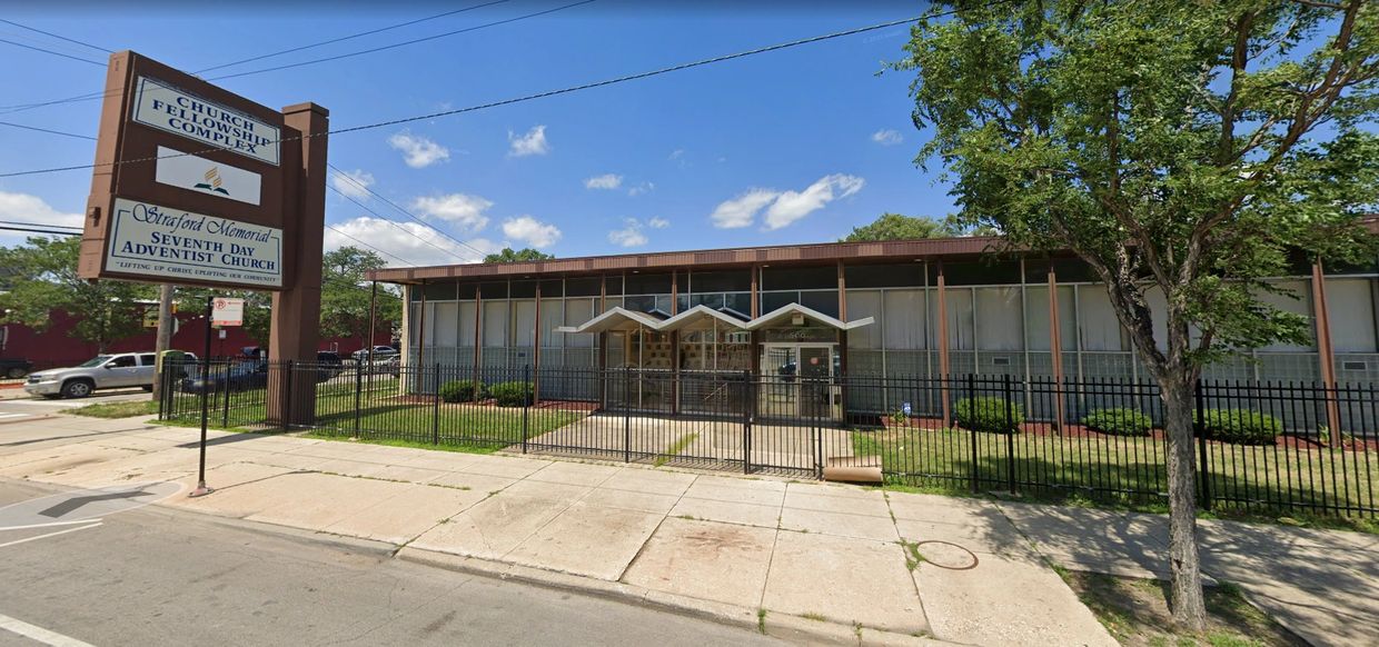 Exterior view of a community and senior citizens center with a fenced yard.