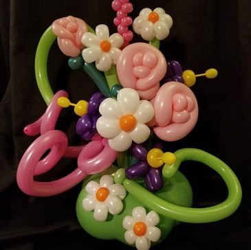Twisted balloon flower bouquet in pink and purple. Roses, daisies and fantasy flowers.