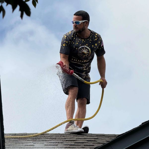 Dorado Wash Company Owner Professional pressure washing cleaning a residential home exterior.