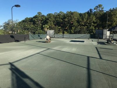 Contractor inspecting tennis court surface south carolina north carolina