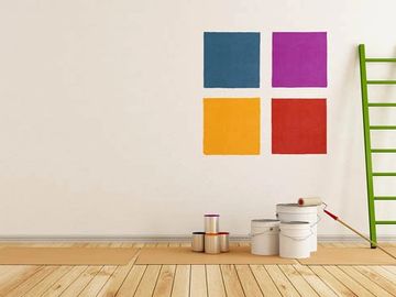 Paint buckets on floor and colours on wall