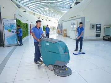 Cleaners cleaning floor in building