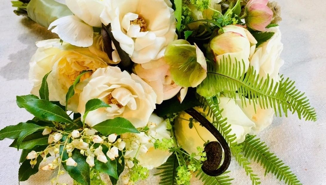 Bridal bouquet of hellebores, piers, garden rose, uhule and umbrella fern and alchimellia. 