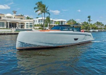 Dark-hull express runabout at a waterfront dock, pre-purchase survey of a power boat