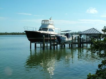 custom dock with dual boat lifts and canopy