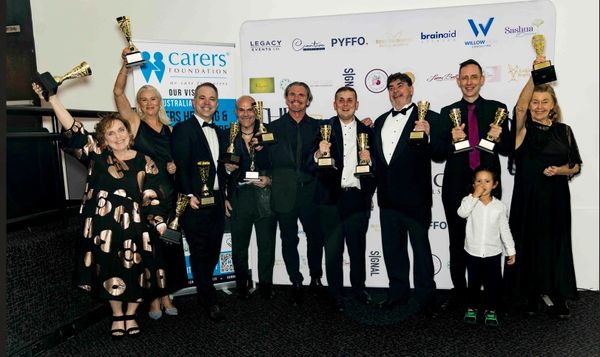 Leone Wilson celebrating alongside fellow award recipients at the INSPiRE Awards 2026 ceremony.