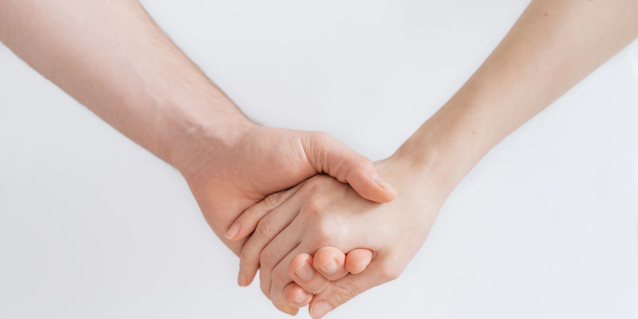 Two people holding hands - trust