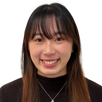Smiling young woman with long hair and bangs.