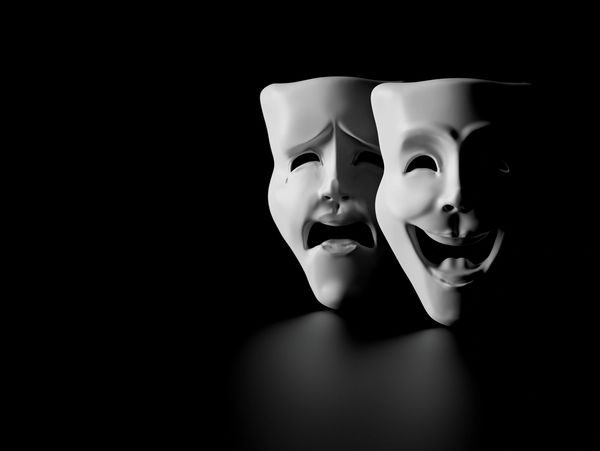 theater masks of drama and comedy on a black background