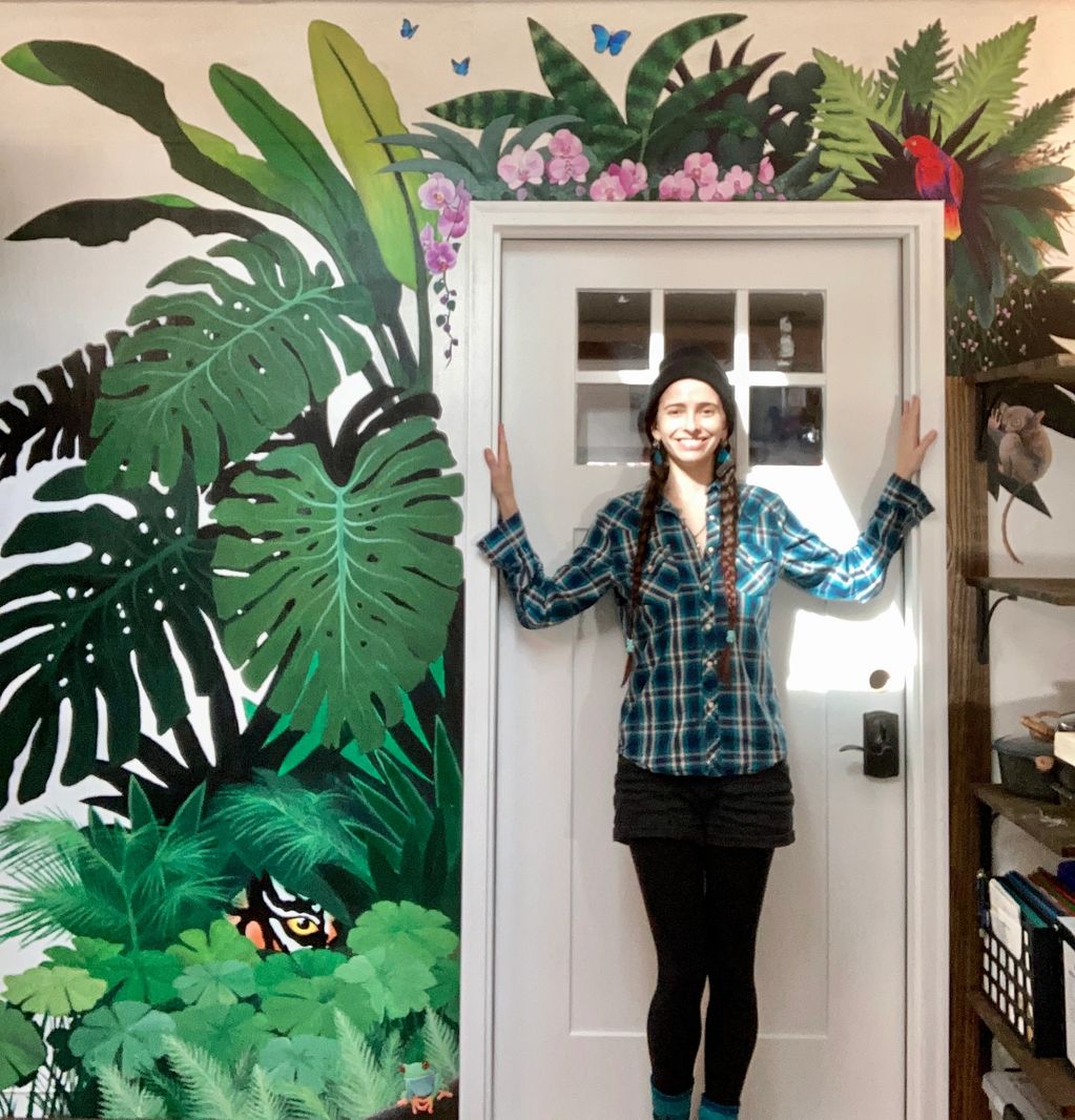 woman with jungle mural plants tiger eye staring out