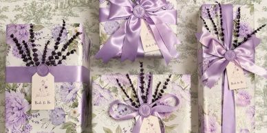 Elegantly wrapped gifts with lavender-themed paper and purple ribbons.