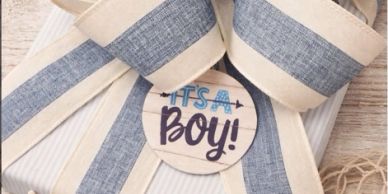 A baby shower decoration with a bow and 'It's a Boy!' sign.