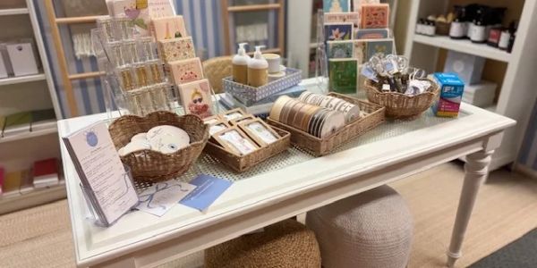 A tabletop display of stationery and gift items in a cozy shop.