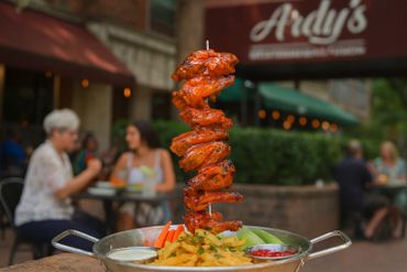 Crispy buffalo wings stacked high, glazed in spicy sauce, and s. A bold favorite in Addison, TX.