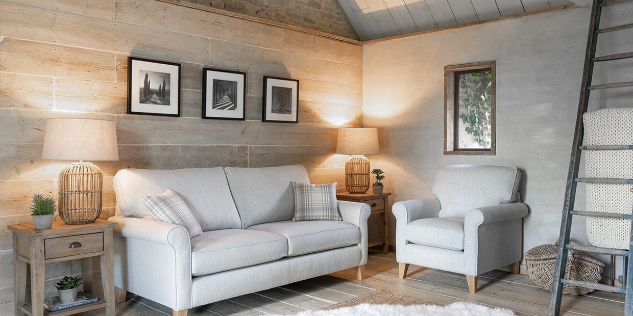 Cozy living room with light furniture and wooden accents.