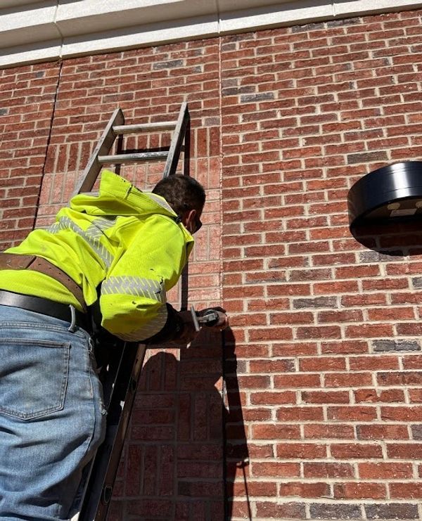 Caulk installation on brick wall