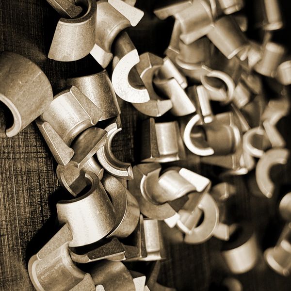Close-up of scattered metal clamps on a wooden surface.