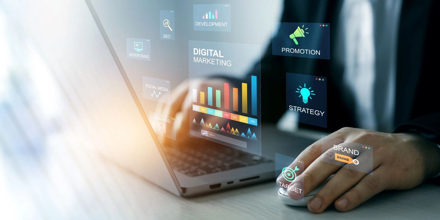 Person using laptop with digital marketing concepts and charts displayed.