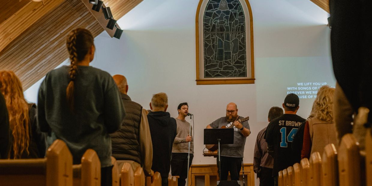 People attending a church service with live music.