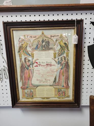 Framed vintage birth and baptism certificate with angels and colorful birds.
