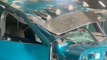 A teal blue truck windshield view with chrome details