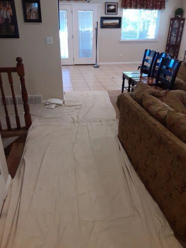 Tarping the areas we are not cleaning to protect the home from damage