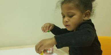 Young child playing attentively with toys.