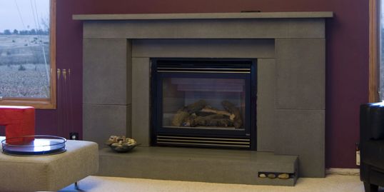 Concrete fireplace hearth, mantle, and surround.