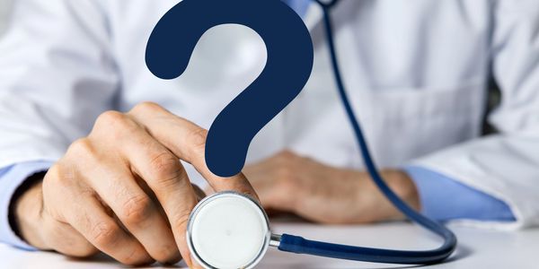 Photo of doctor holding stethoscope where the round portion is the dot of a question mark