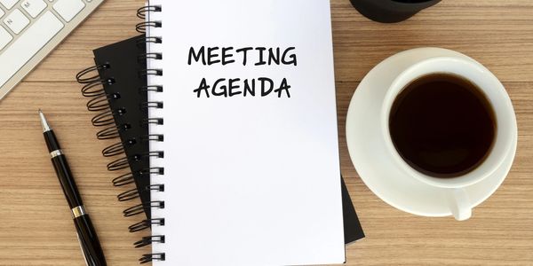 Image of notebook with the wording "Meeting Agenda"