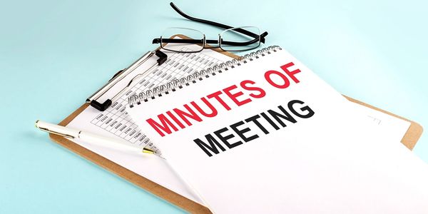 Image of notebook and clipboard with the wording "Meeting of Minutes"