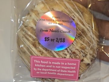 Packaged Pecan Marble Crunch cookie with price and health warning labels.