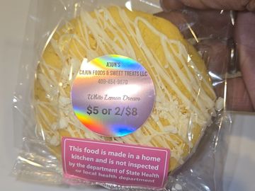 Packaged white lemon dream cookies with pricing and safety labels.
