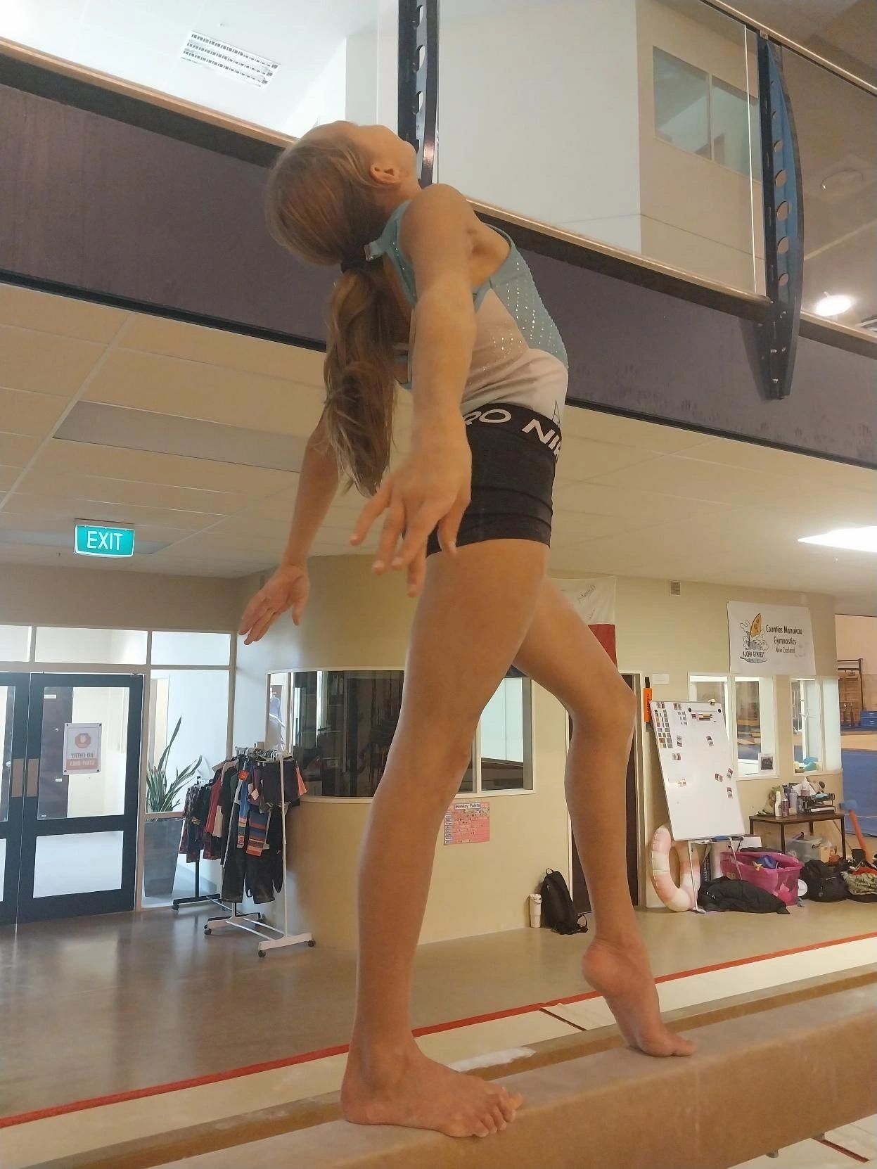 Gymnast arching back on the balance beam
