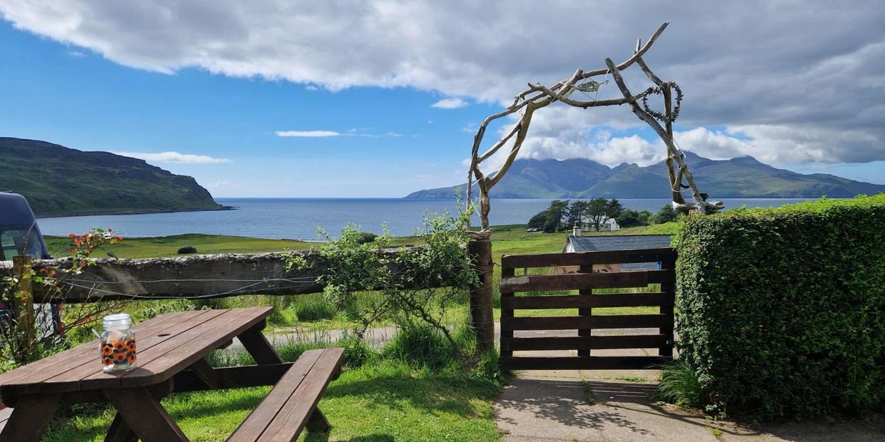 View from garden on Isle of Eigg looking out to sea. Scottish island landscape coastal scenery hills