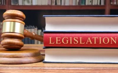 Gavel and legislation book on desk.