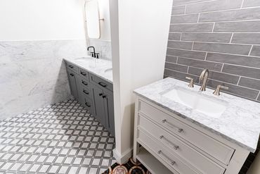 bathroom with grey brick accent wall