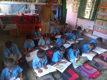 group of kids sitting on floor for class