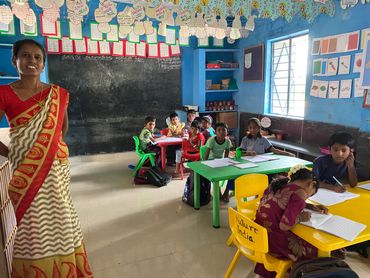 Elementary school teacher and students in their classroom