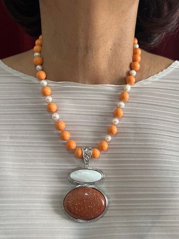 Handmadee necklace with orange Shell Pearls, Fresh Water Pearls and brown Sandstone/ Shell Pendant.