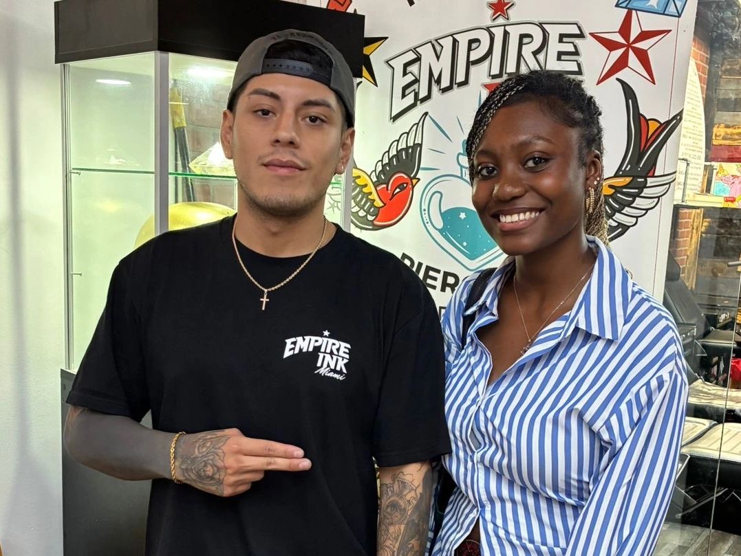 Empire ink miami tattoo artist with happy client showing off their ink