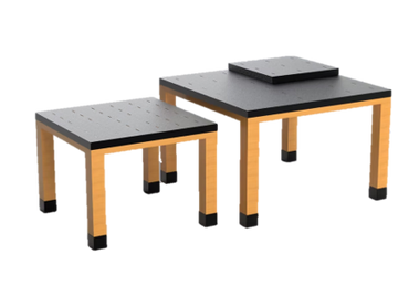 Two modern square tables with wooden legs and dark tops.