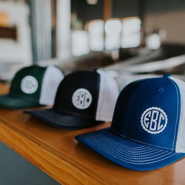 A picture of three EBC hats sitting on the ledge.