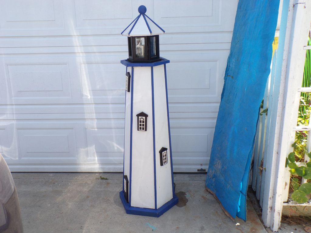 This is a handcrafted lighthouse with a revolving beacon light. Each lighthouse is made one at a tim